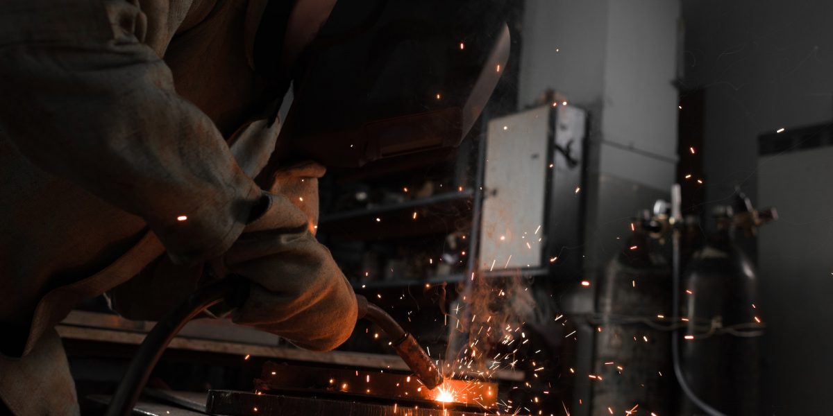 Manufacture Worker Welding Metal With Sparks at Factory